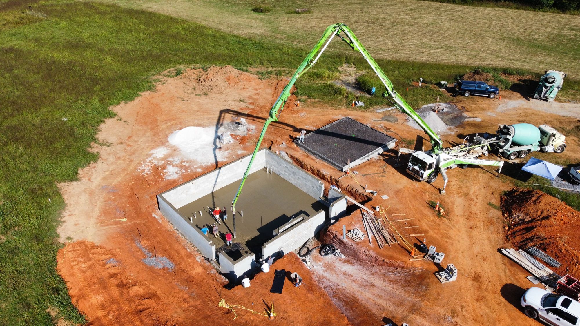 Aerial view of a concrete pump placing a basement wall pour