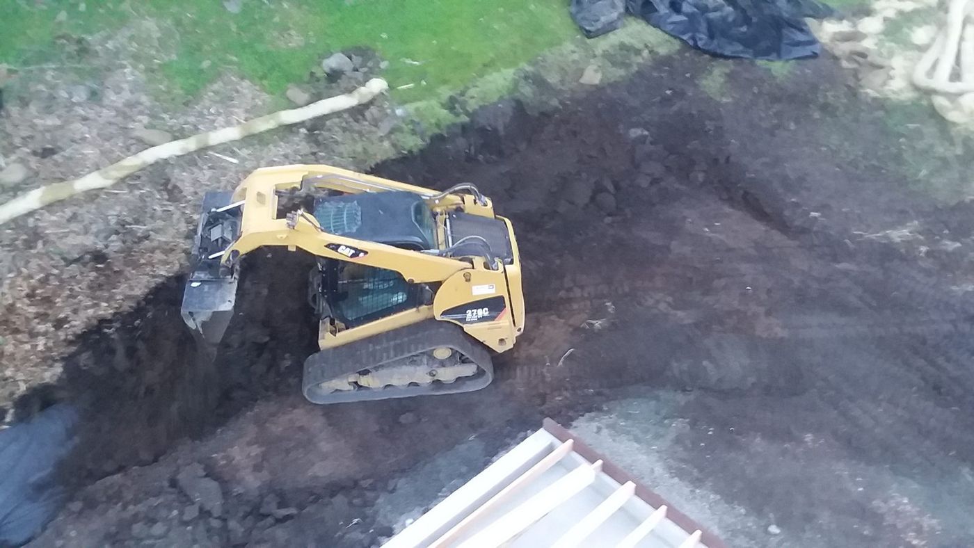 Aerial view of a track loader cutting a slope